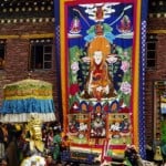 A "Thangka," is a Tibetan silk painting with embroidery, usually depicting a Buddhist deity, famous scene, or mandala of some sort.