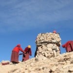 nuns are piling up this mini pile at Everest region