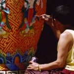 A Tibetan painter is painting at a big vase at Kanze monsatery of Kham