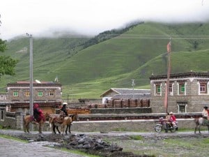 Tibetan Family on the horse back and motorcycle